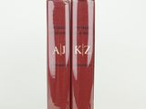 pair of two red books sitting next to each other on a white surface