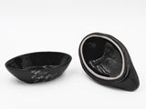 a black bowl and a black bowl on a white surface