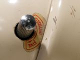 a close up of a sewing machine with a button on it