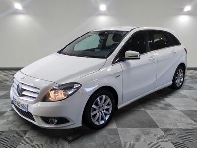 the mercedes b - class is parked on a checkered tile floor