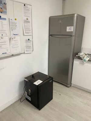a refrigerator and a refrigerator freezer in a small room