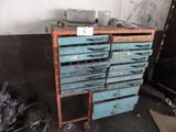 a blue cabinet with many drawers on it in a room