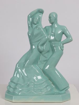 a statue of a man and a woman on a rock