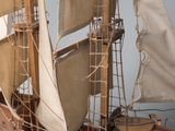 a wooden model of a sail boat on a table