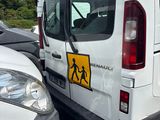vehicles parked in a parking lot with a pedestrian crossing sign on the back of the van