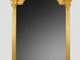 une image d'un miroir encadré d'or sur un fond blanc