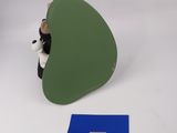a stuffed animal that is sitting next to a piece of paper