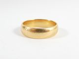 a close up of a gold ring on a white surface