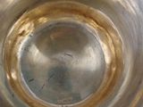 a close up of a metal bowl with a liquid inside of it
