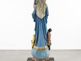 the statue of the virgin mary is sitting on a small cart
