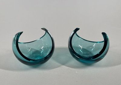 pair of blue glass vases on a white surface