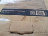a cardboard box with a piece of pizza in it