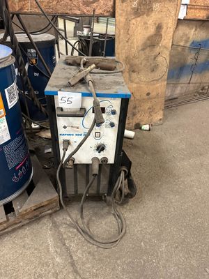 a machine that is sitting on a pallet next to a water tank