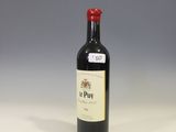 a bottle of wine sitting on a counter in a kitchen