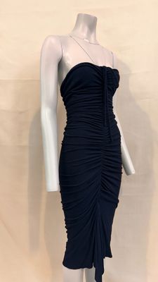 the mannequin is wearing a black dress with a ruched skirt