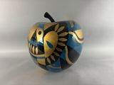 a blue and gold apple with a fish design on it