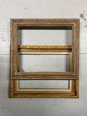 an old picture frame hanging on a wall next to a white wall