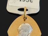 a close up of a gold medal with a baby on it