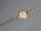a gold wrist watch with a white face on a silver background
