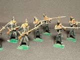 the toy soldiers are dressed in uniform and holding their weapons