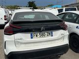 a white car parked in a parking lot next to other cars
