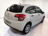 a picture of a white car parked in a garage