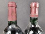 two bottles of wine that are sitting on a table