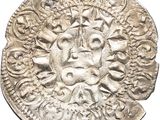 a close up of a silver coin with a face on it