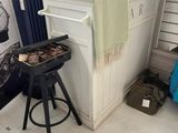 an image of a kitchen with a bar stool and a grill