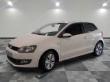 the white volkswagen polo is parked in a room with a checkered floor