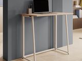 a desk with a laptop on top of it in a room