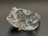 a glass object that looks like a fish on a table