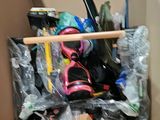 a cardboard box filled with assorted items and a pair of skis