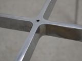a close up view of a metal cross on a concrete floor
