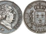 a silver coin with a crown on top of it