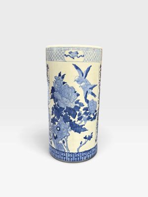 a blue and white vase with flowers and birds on it