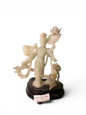 statue of a woman holding a bird and a cat on a black base