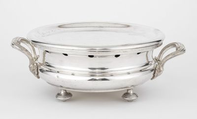 a silverplated bowl with handles and handles on a stand
