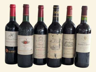 several bottles of wine are lined up in a row
