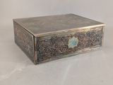 an antique silver box with a blue stone in the middle of it