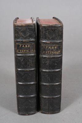 pair of antique black leather books sitting on top of each other