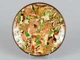 a plate with a colorful design on it sitting on a table