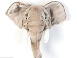 a stuffed elephant head mounted on the wall