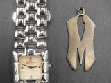 an image of a watch and a keychain sitting on a table