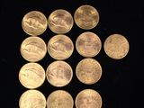 several coins are arranged in a triangle on a black surface