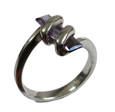 un gros plan d'une bague en argent sertie d'une pierre violette