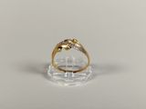 a close up of a gold ring with diamonds on a clear surface