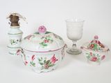 a white table topped with a bowl and a glass
