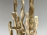 a close up of a metal sculpture of a group of people