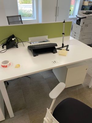 a white desk with a printer and a printer on it